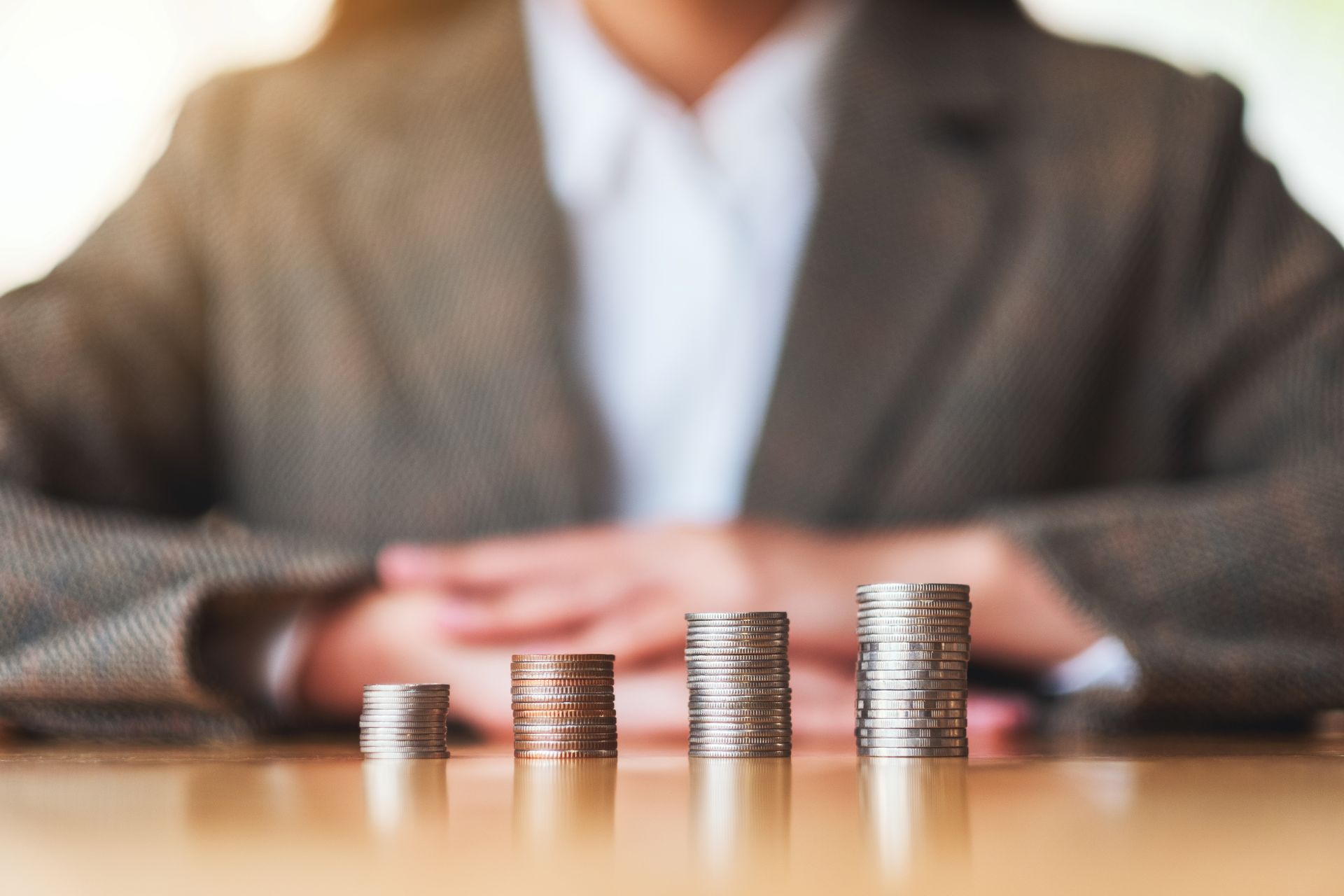 businesswoman-stacking-coins-on-the-table-for-savi-2024-11-27-17-23-33-utc
